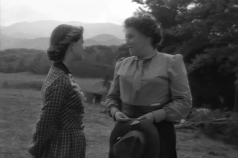 Christy and Miss Alice standing outside the schoolhouse